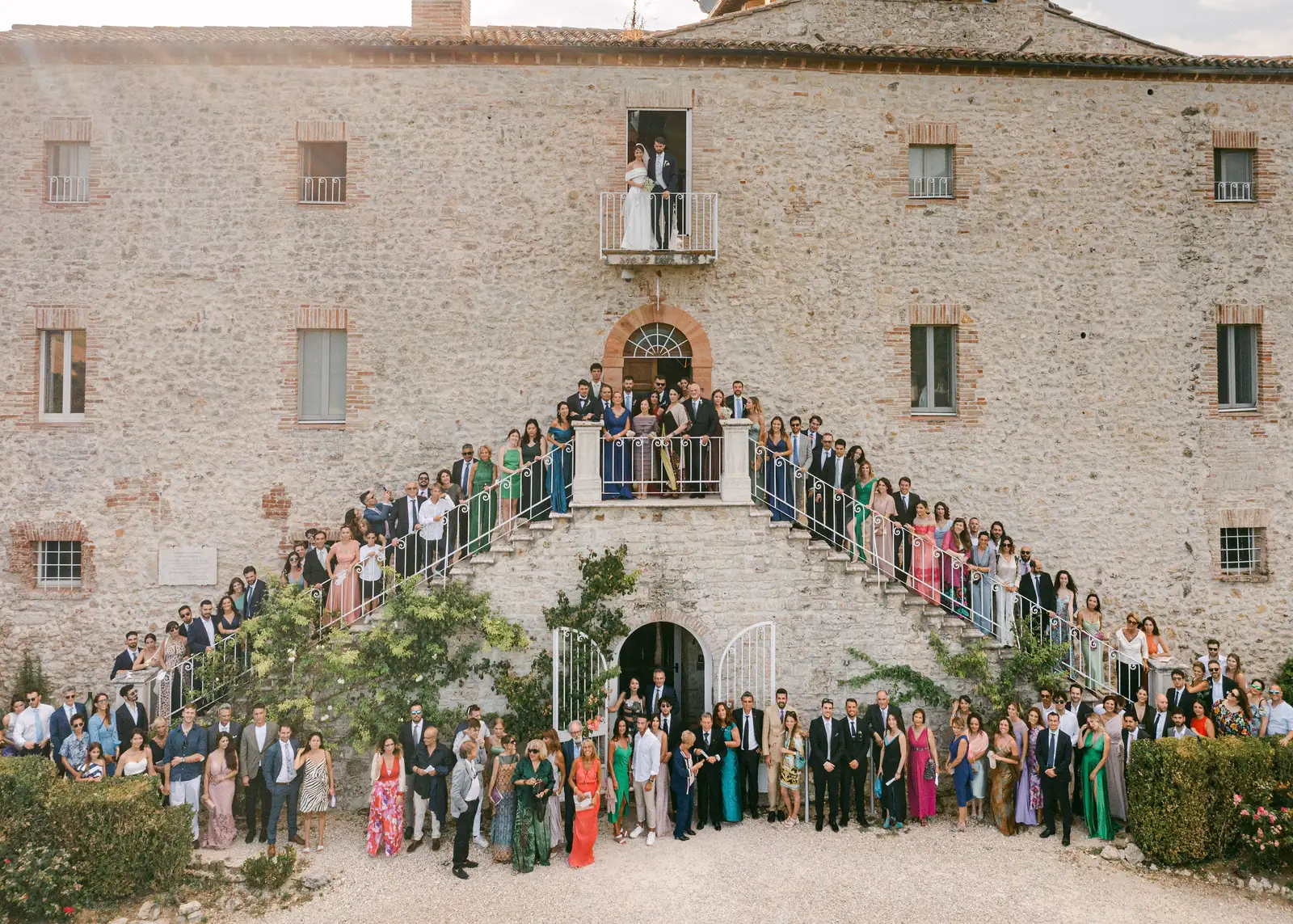 Foto di gruppo con tutti gli invitati sulla scalinata del Castello di Montignano