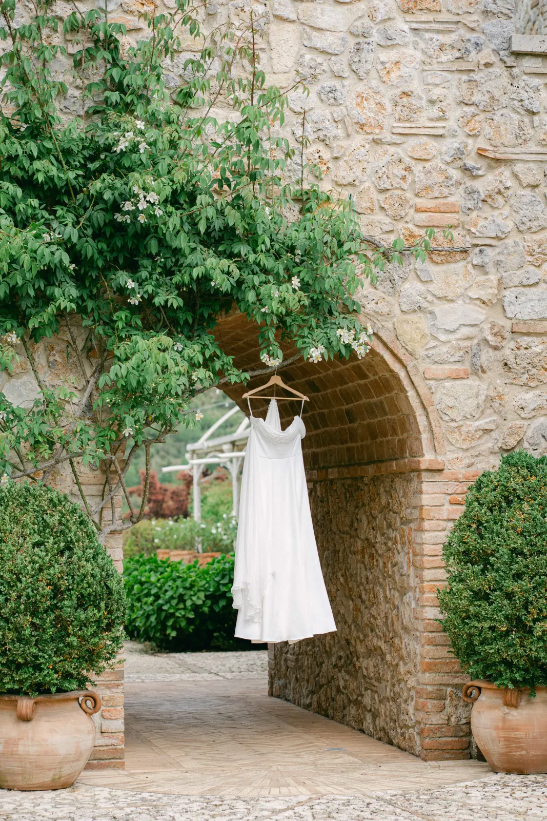 Wedding dress hanging stone archway